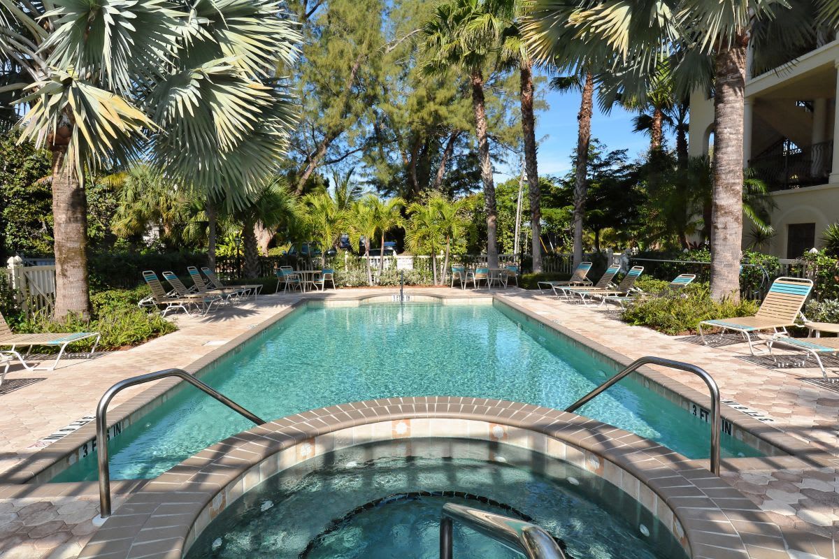 Soak up the sun by your private pool and hot tub, surrounded by swaying palms and lush tropical gardens—your perfect retreat awaits.