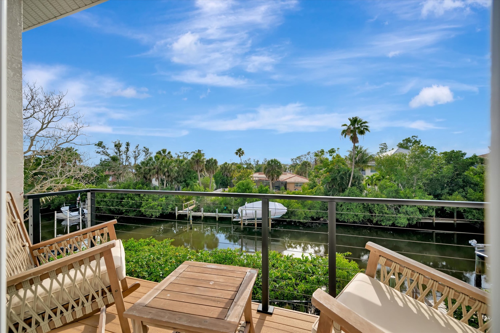 Step onto your private balcony and take in the tranquil waterway views framed by swaying palms and lush greenery—the perfect spot for morning coffee or sunset relaxation.