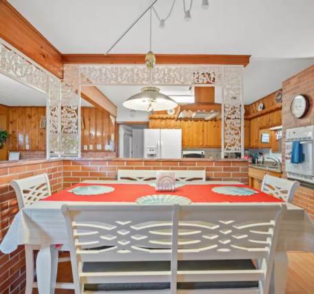 Gather around the bright dining table where your group can share stories, plan adventures, or simply enjoy meals together in this open, sun-filled space.
