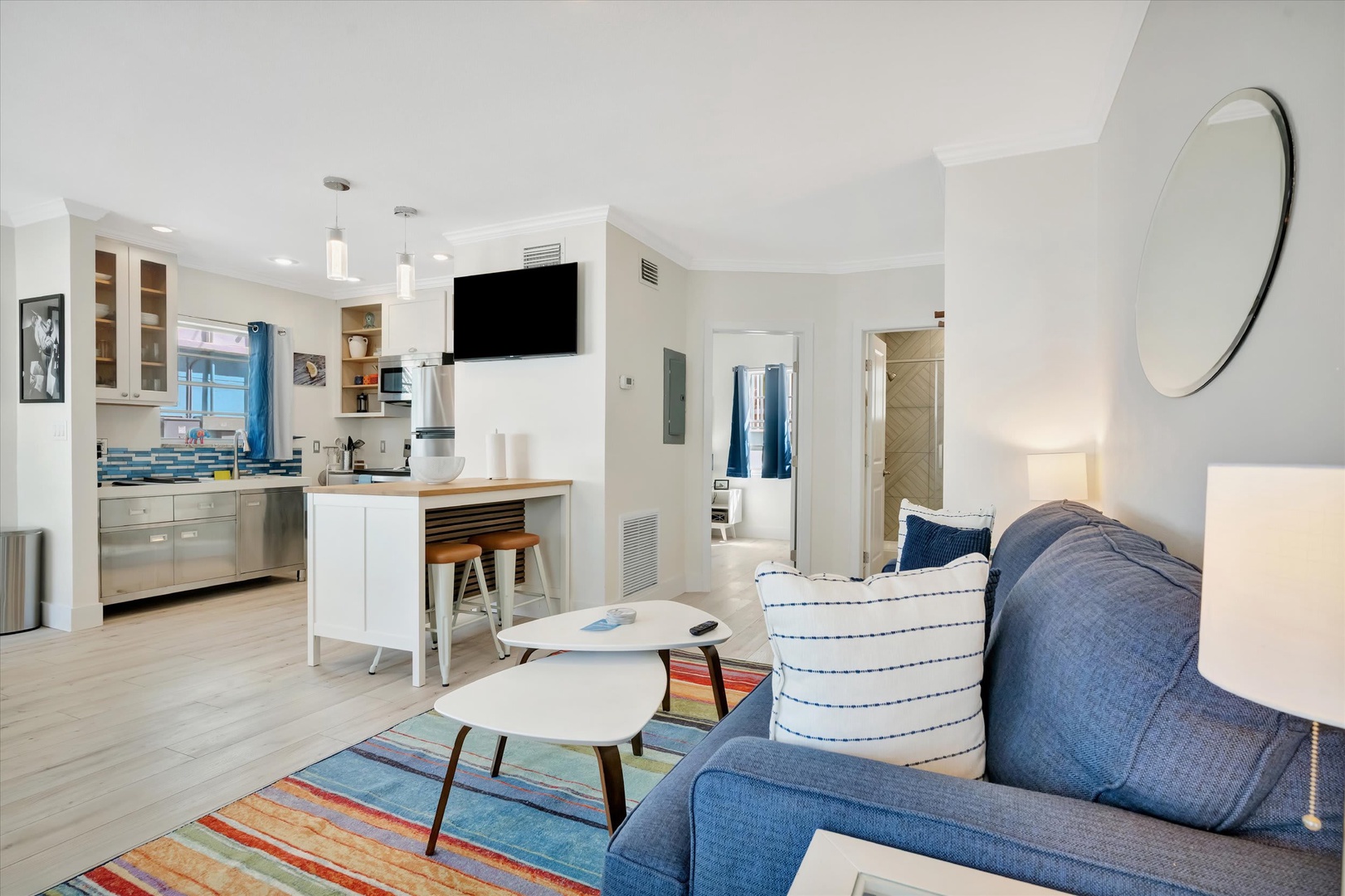 Settle into your bright, open living space where coastal blues and clean lines meet comfort. The kitchen flows seamlessly into your lounge—perfect for lazy mornings and easy evenings.
