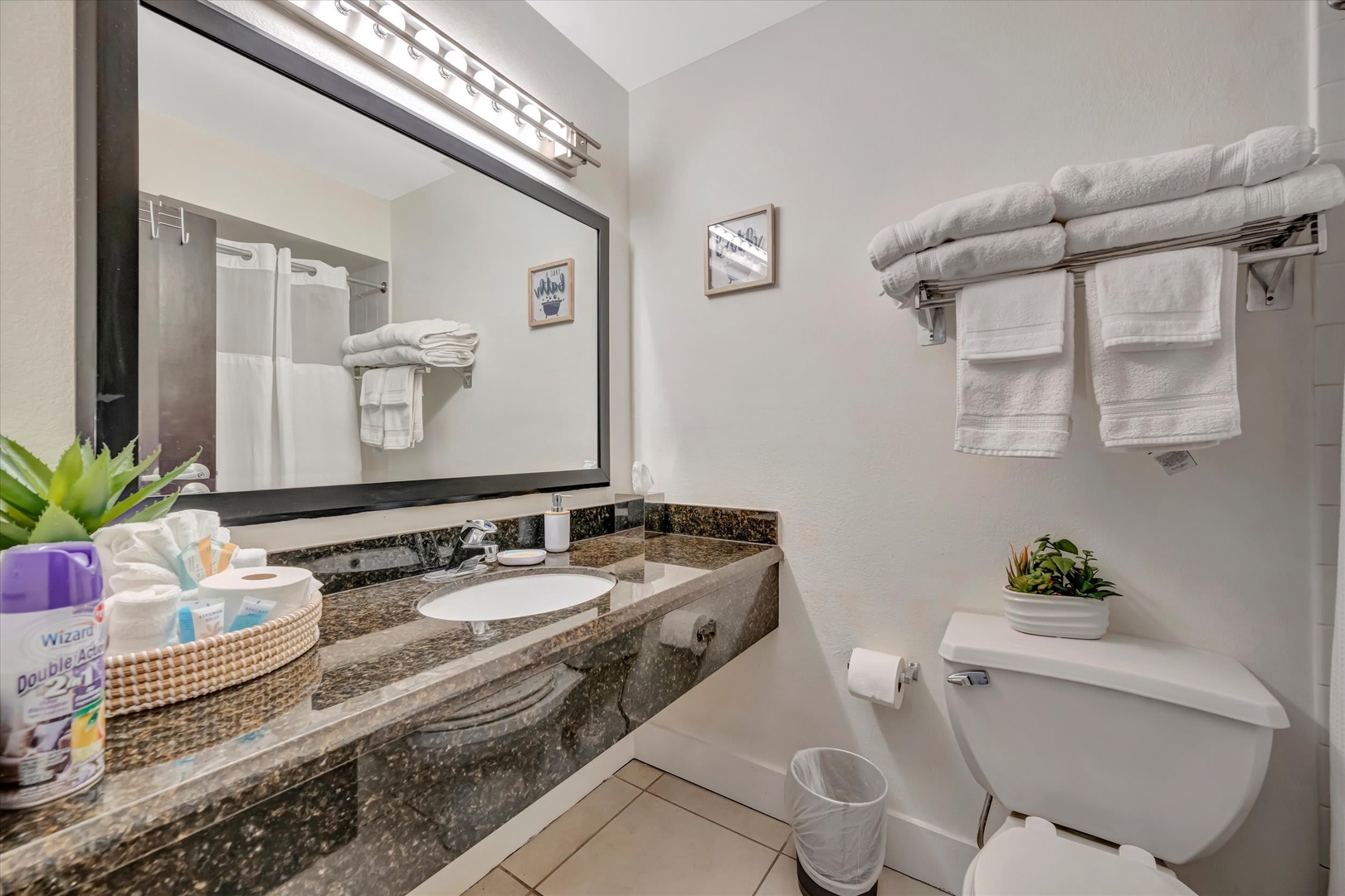 Step into your fresh, well-appointed bathroom with plush towels and modern granite finishes. Everything you need is thoughtfully provided for your comfort and convenience.