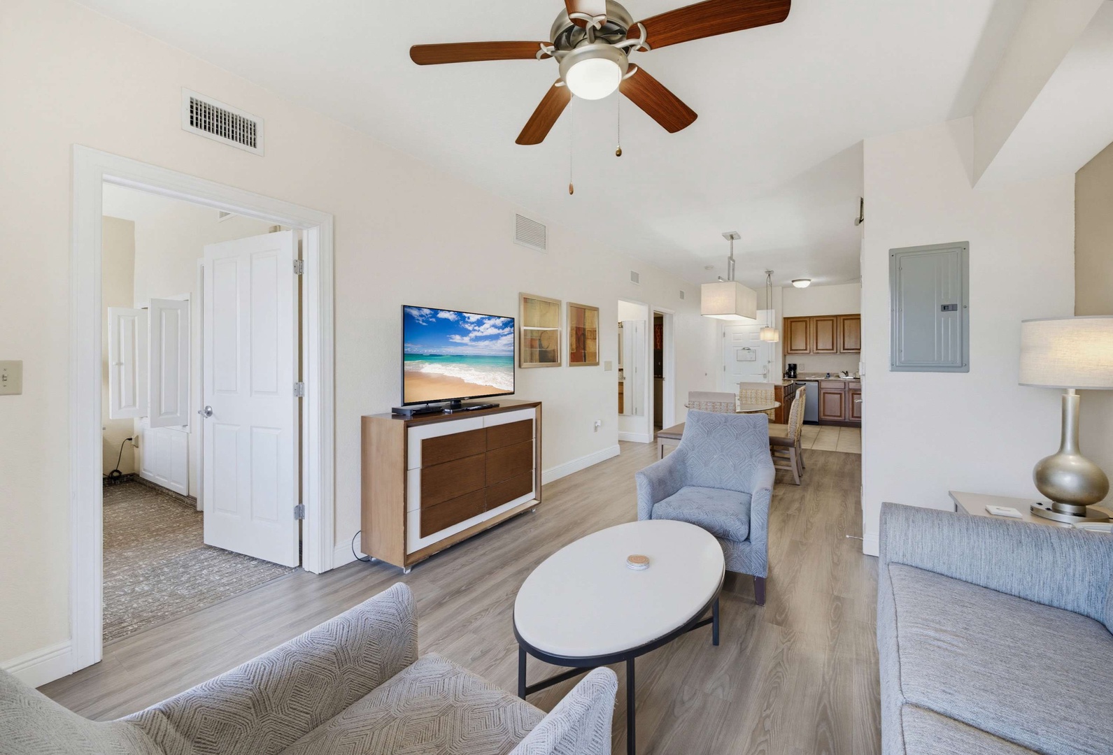 Step into your bright, airy living space where vaulted ceilings and gentle ceiling fans create a breezy atmosphere. Comfortable seating invites you to relax, while the open flow to the kitchen makes entertaining effortless.