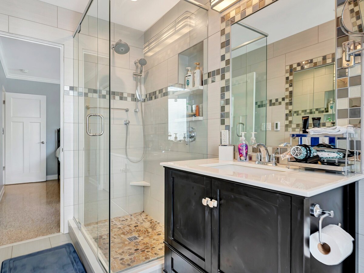 Step into your spa-like bathroom with a spacious walk-in shower, elegant mosaic tilework, and a sleek vanity. Everything you need to refresh and recharge.
