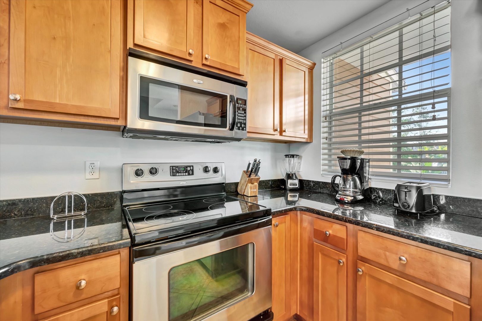 Your fully equipped kitchen features sleek granite countertops, stainless appliances, and everything you need to whip up meals during your stay—from morning coffee to home-cooked dinners.