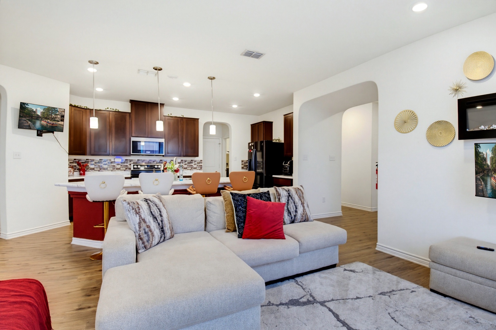 Sink into plush seating in your open-concept living space where contemporary design meets comfort. Your kitchen awaits with modern appliances and warm wood cabinetry—perfect for gathering and unwinding.