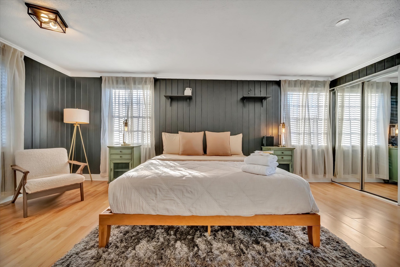 Unwind in your serene bedroom, where warm wood tones and soft lighting create a peaceful retreat. Crisp linens and plush towels are ready for your arrival.