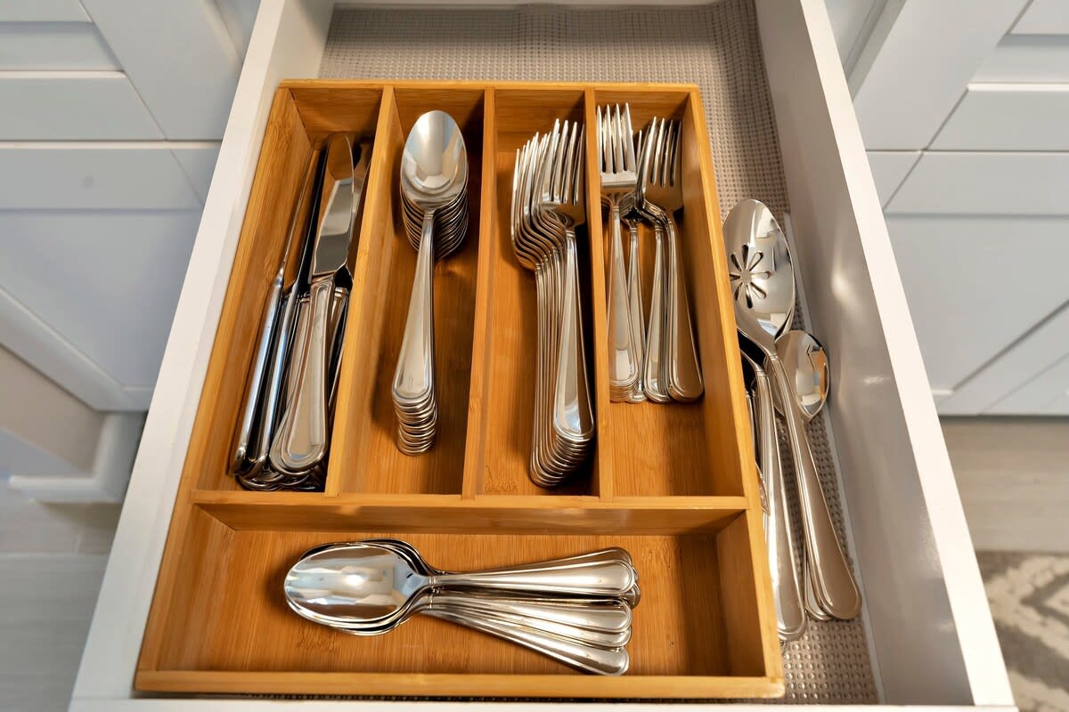 Everything you need is right where you expect it—a well-organized drawer with quality flatware and serving pieces ready for your meals.