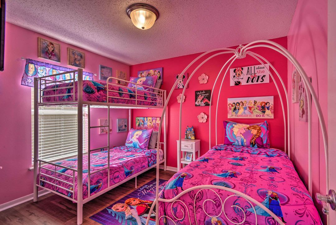 Step into your own fairytale kingdom with vibrant pink walls, whimsical decor, and cozy beds styled just for you. Perfect for making magical memories with your little ones.
