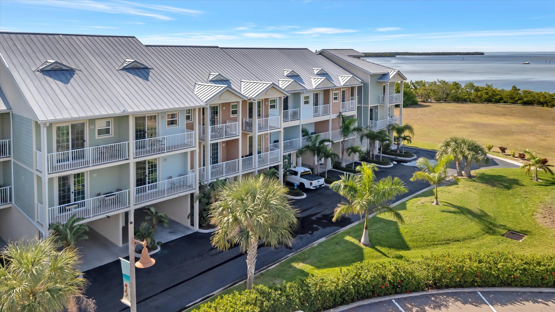 Coastal paradise awaits at this stunning waterfront property, surrounded by lush tropical landscaping and expansive bay views. Multiple balconies offer serene vistas of the water and natural scenery.