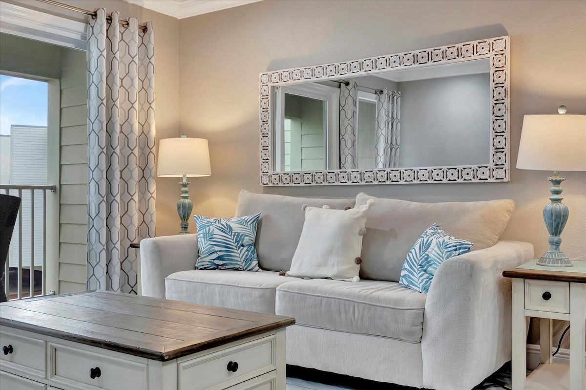 Settle into your bright, coastal-inspired living space where soft textures and natural light create the perfect spot to unwind after a day of adventure.