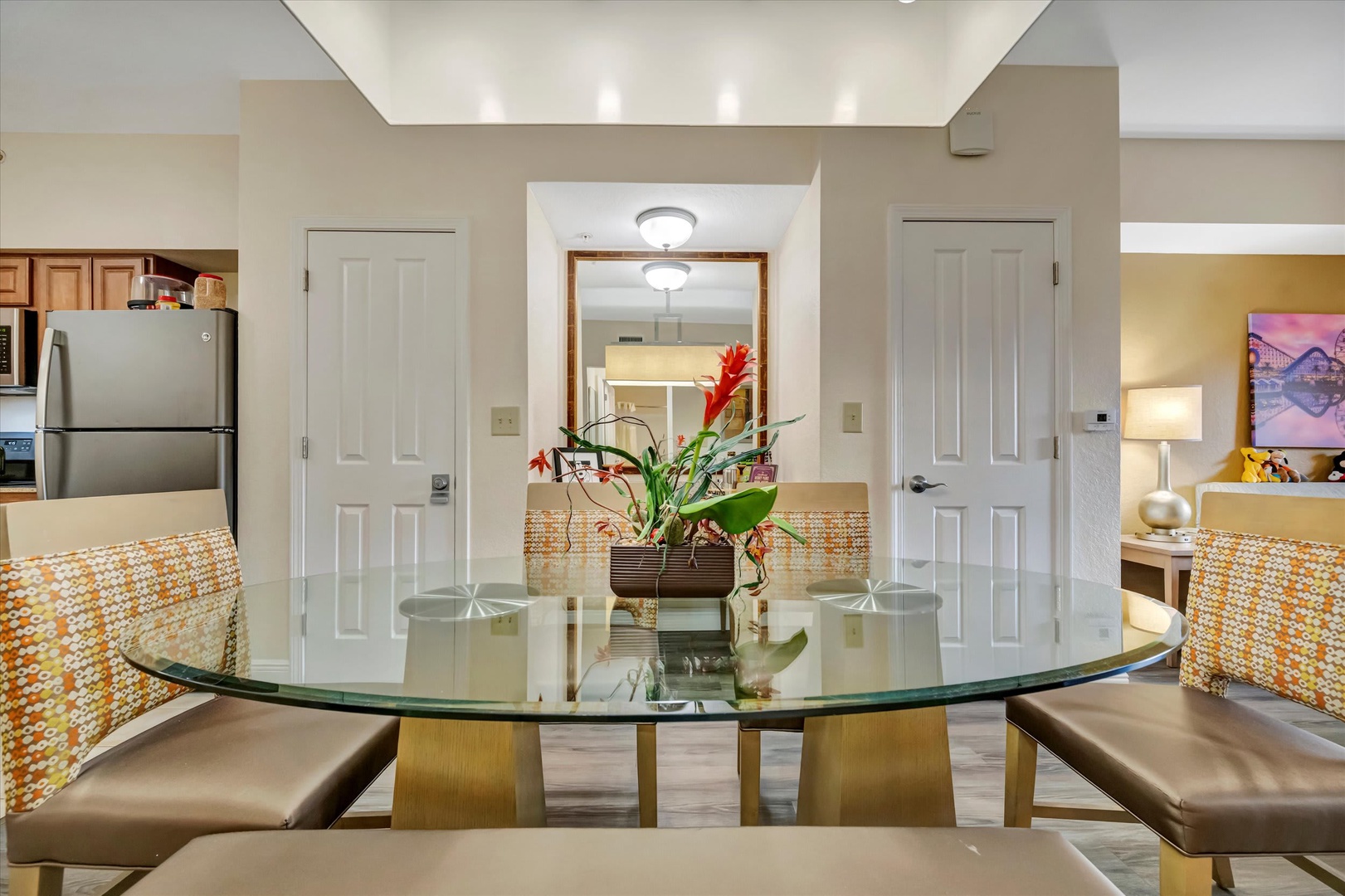 Gather around your spacious glass dining table, where modern elegance meets everyday comfort. The open layout connects seamlessly to your fully-equipped kitchen, making meals and conversation flow effortlessly.