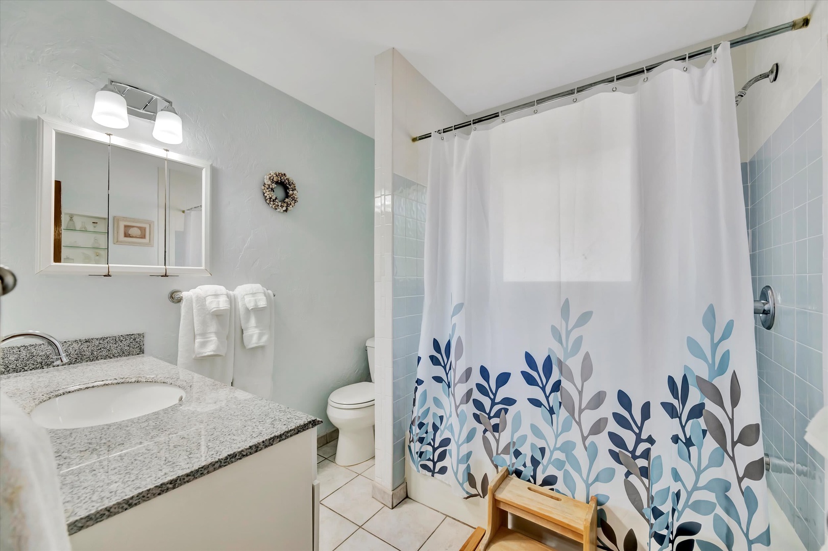Refresh in your own bright, coastal-inspired bathroom with soft blue tones, stylish granite finishes, and plush towels ready for you after each shower.
