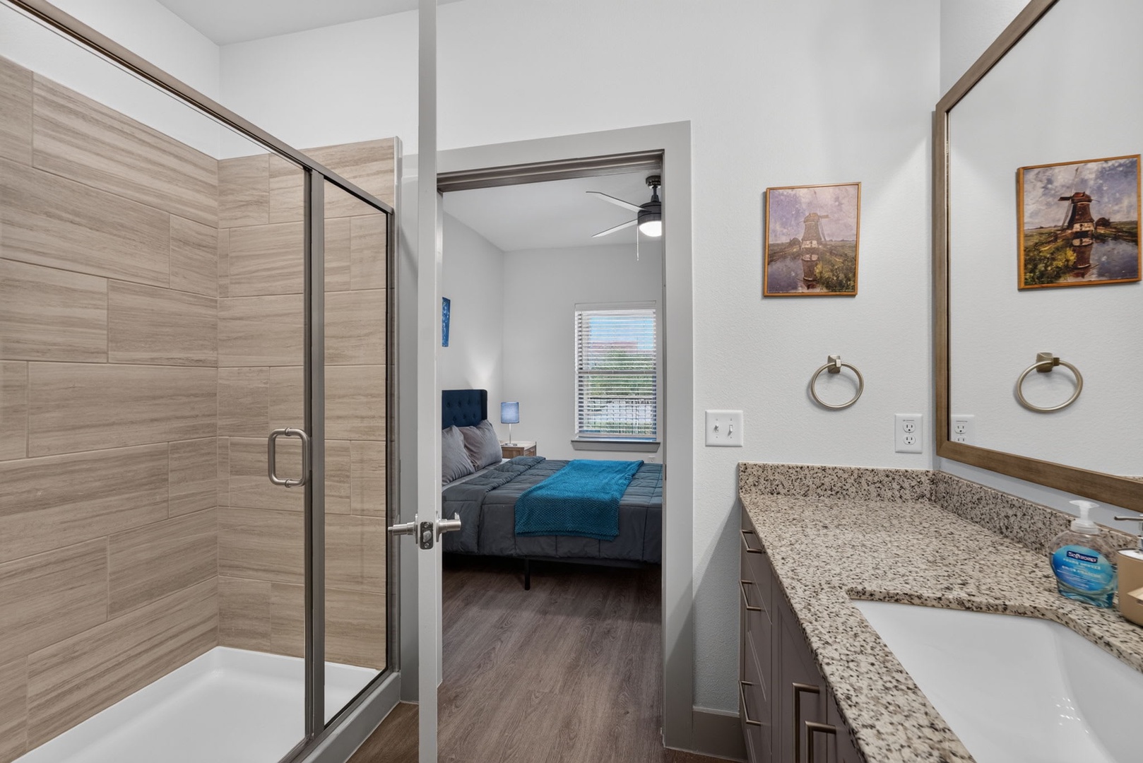 Step into your modern en-suite bathroom, featuring a spacious walk-in shower and bright vanity space for your morning routine, with the bedroom just steps away.