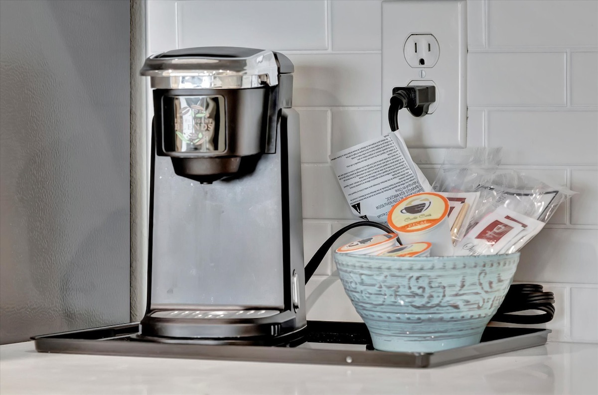 Start your mornings right with your own single-serve coffee maker and a curated basket of teas and treats—everything you need for a cozy coffee break in your space.
