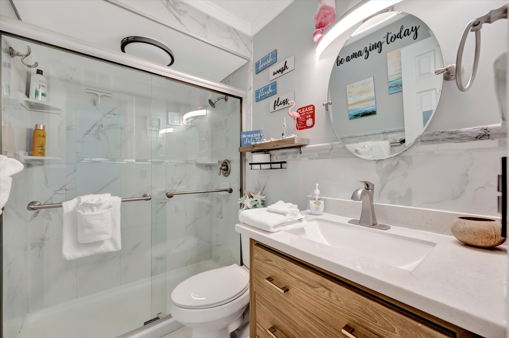 Step into your sparkling, spa-inspired bathroom where fresh towels await and uplifting messages welcome you to unwind. The sleek marble-style finishes and spacious walk-in shower make freshening up a pleasure.
