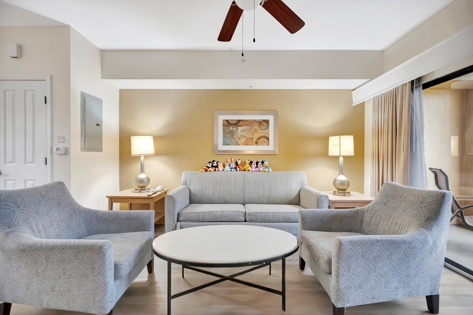 Settle into your spacious living area, where soft seating and warm lighting create the perfect atmosphere for relaxing with family after a fun-filled day exploring nearby attractions.