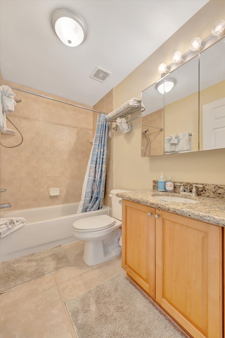 Step into your private bathroom where soft lighting and fresh towels await. Granite counters and a relaxing tub promise comfort after a day of adventure.