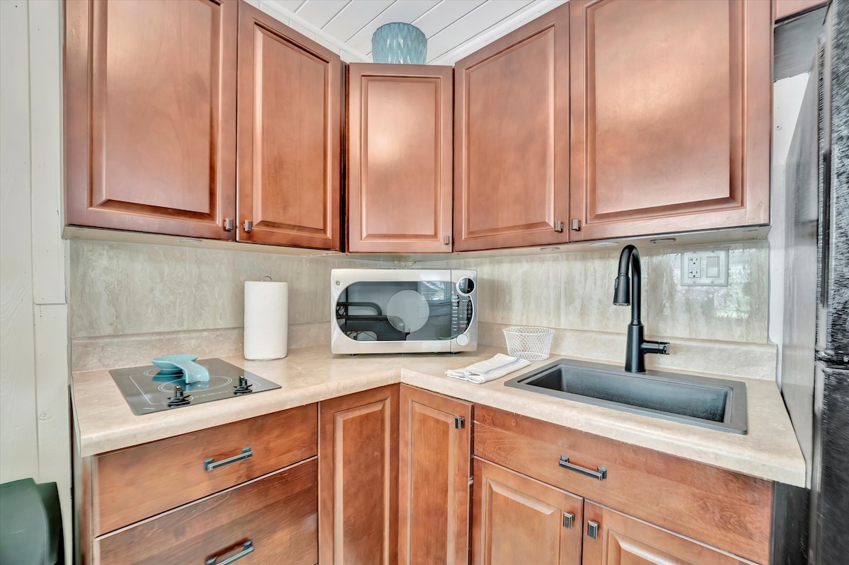 Step into your fully equipped kitchen with warm wood cabinetry, sleek countertops, and modern appliances ready for your culinary adventures.