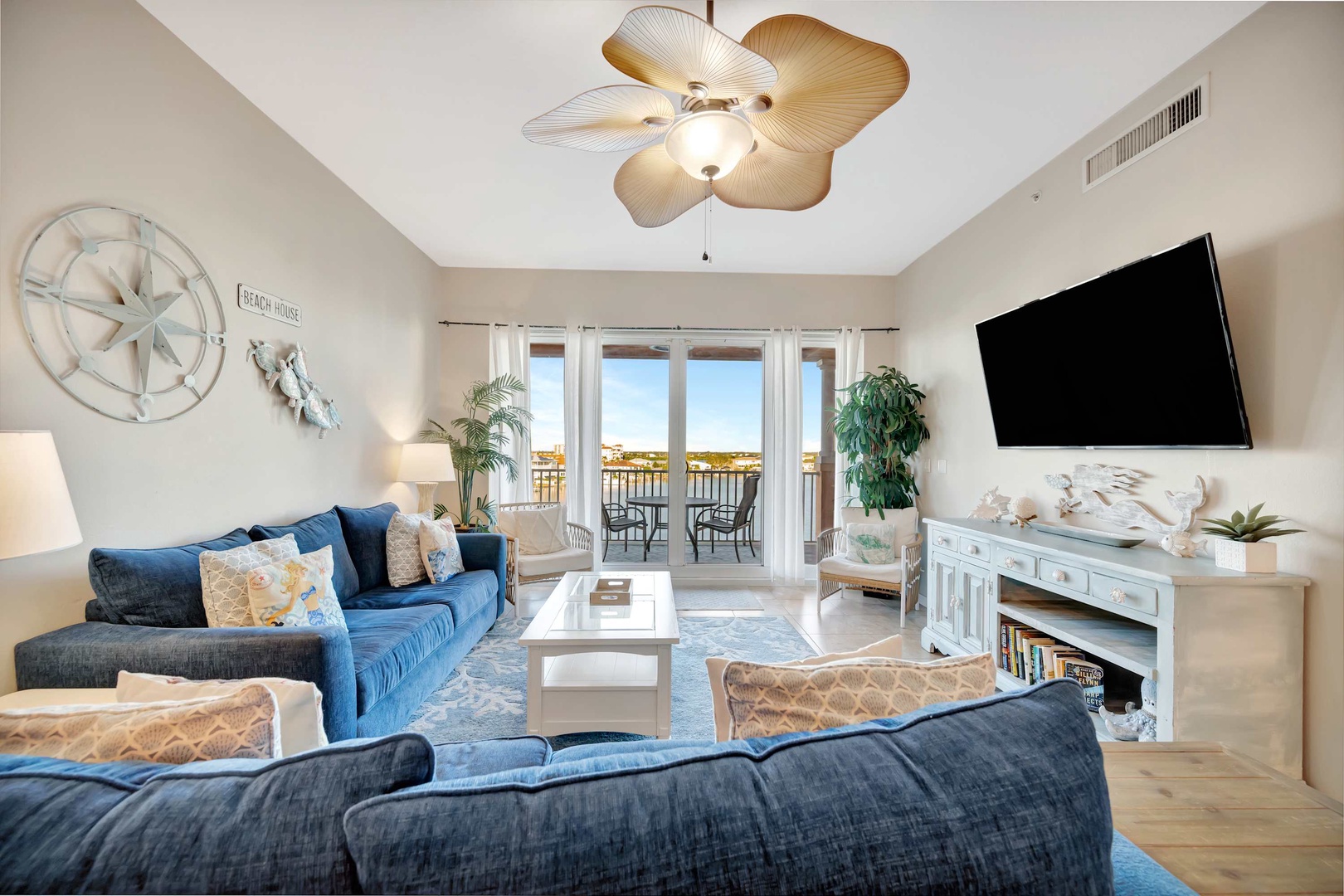 Sink into plush coastal comfort while the waterfront view beyond your balcony sets the scene for relaxation. Your beach-themed retreat awaits with breezy style and plenty of room to unwind.