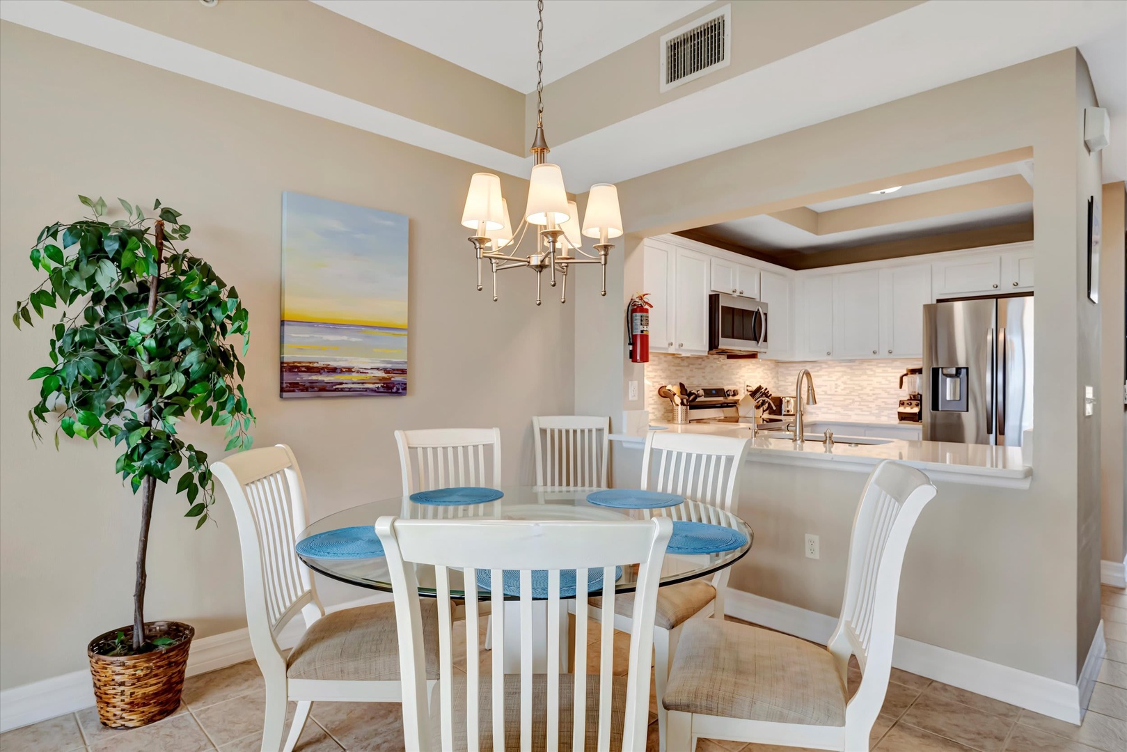 Gather around the bright dining space where coastal charm meets comfort. The open layout flows into your fully equipped kitchen, making mealtime feel effortless.