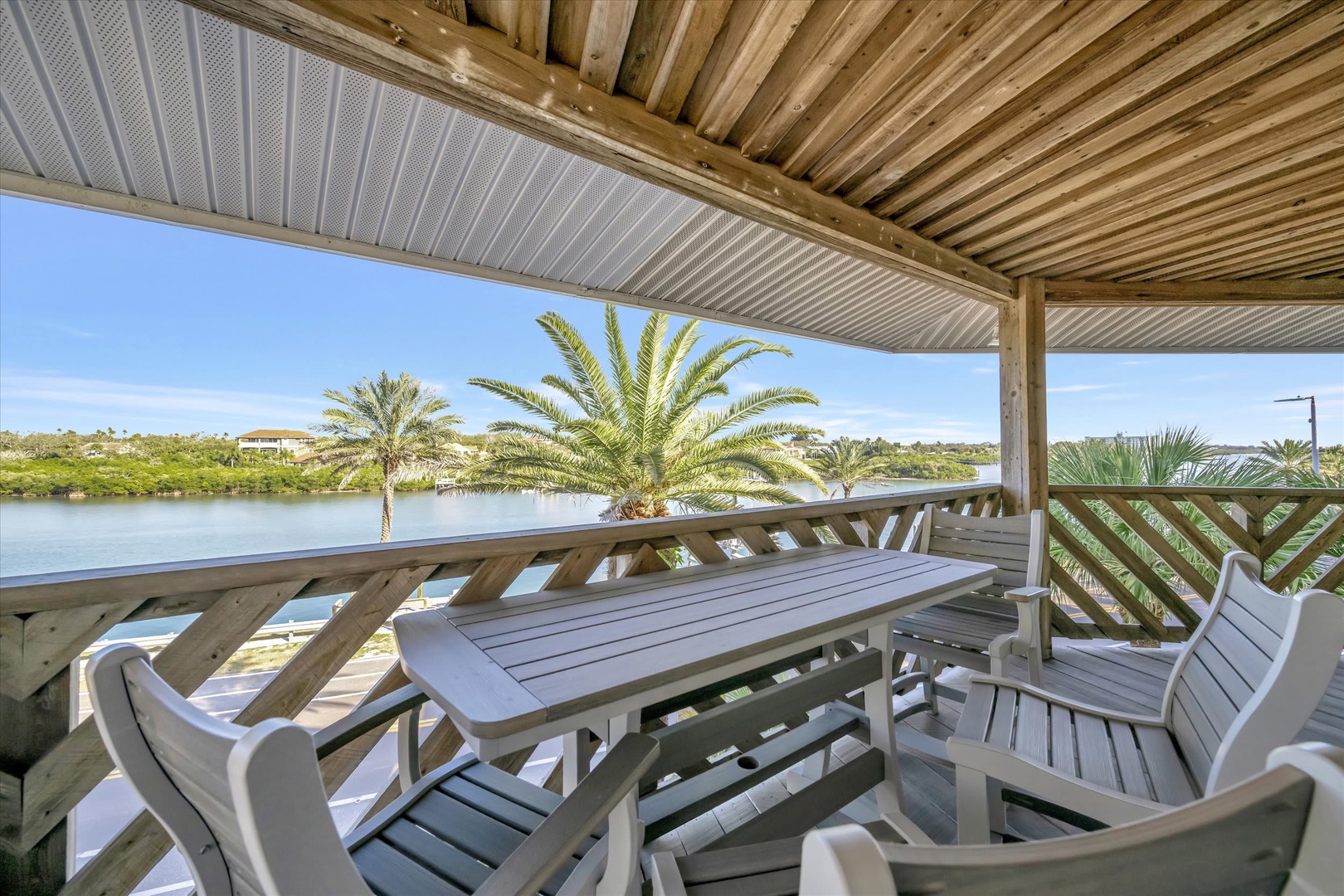 Your private balcony overlooks a tranquil lagoon framed by swaying palms—a perfect spot to unwind with morning coffee or evening drinks while soaking in the serene water views.