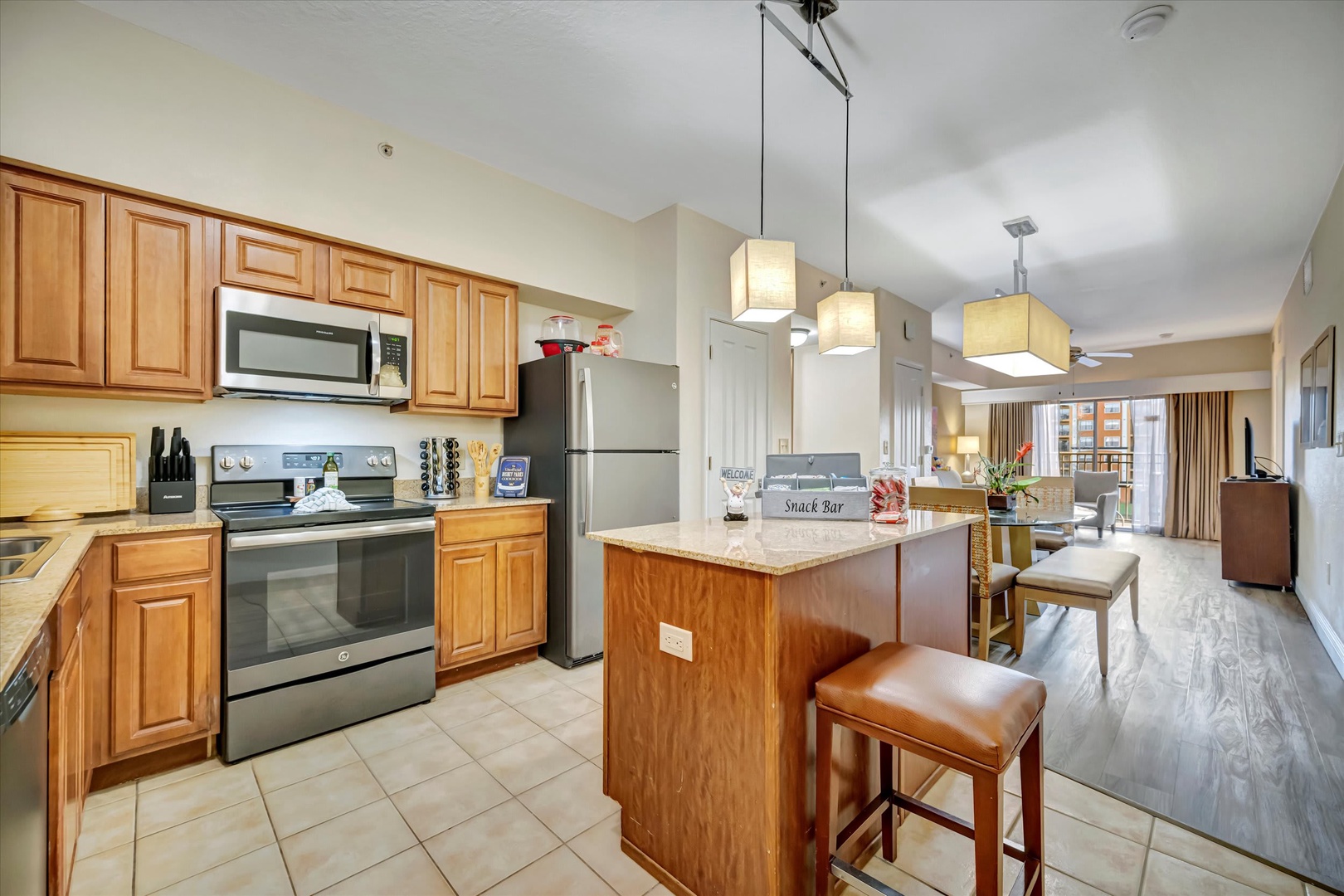 This bright, open layout seamlessly connects the full kitchen with modern appliances to your inviting living space, making it easy to gather and relax throughout your stay.