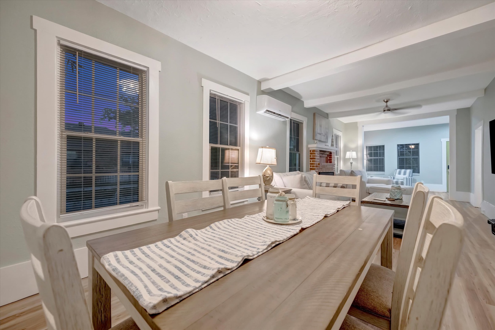 Gather around your spacious dining table for meals with family and friends, then relax in the cozy living area beyond. The open layout and coastal-inspired touches make every moment here feel welcoming and effortless.