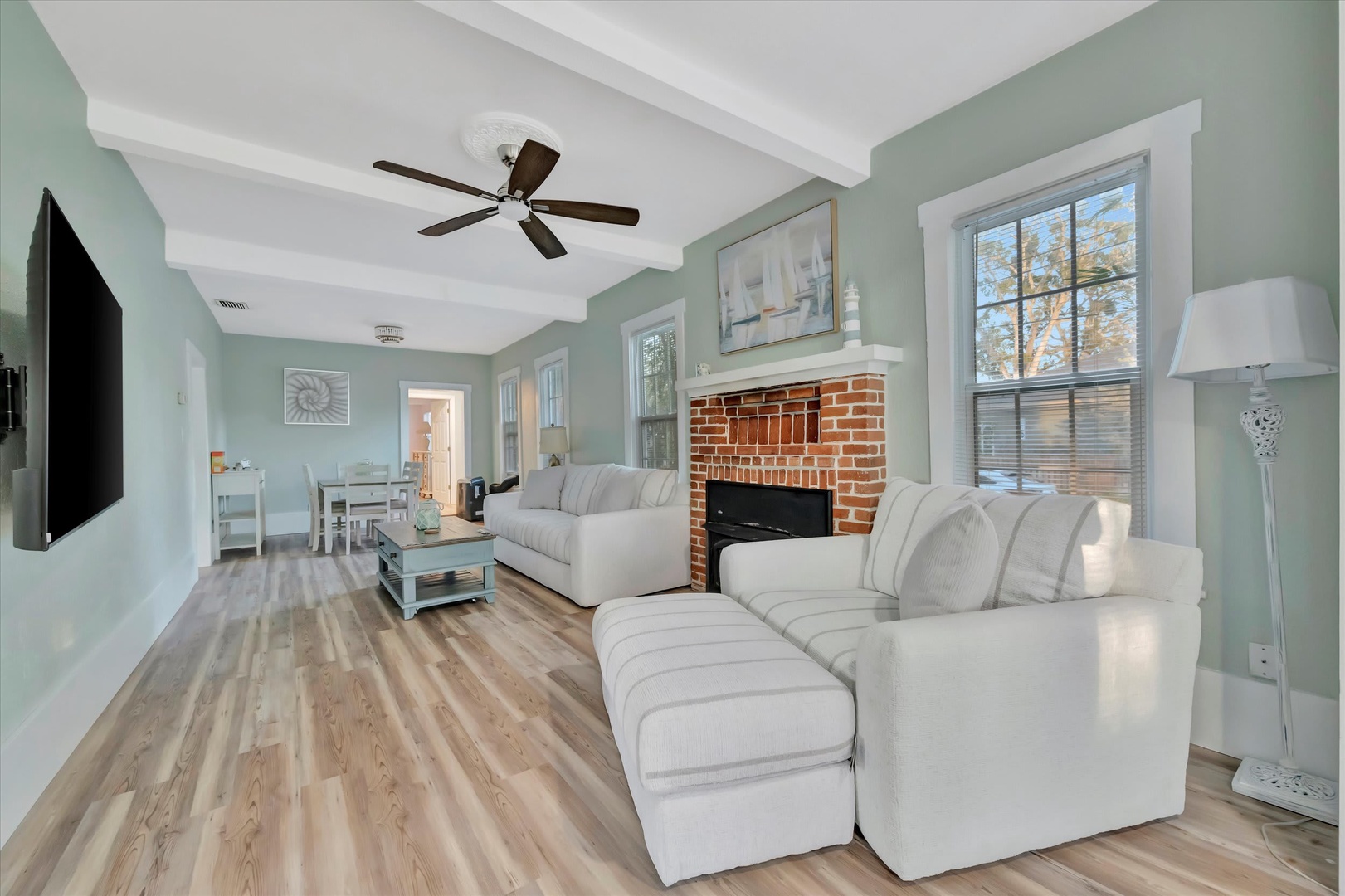 Unwind in your bright, airy living space with a cozy brick fireplace and plush seating—perfect for relaxing after a day of adventure.