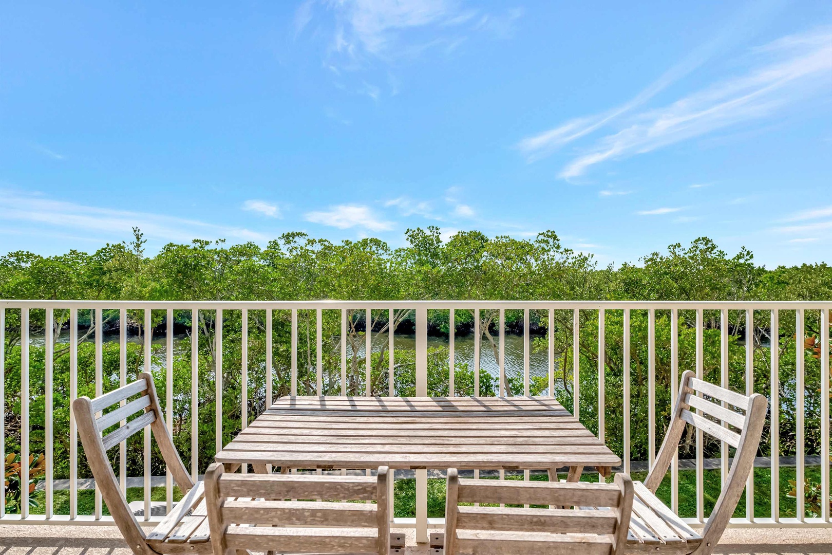 Your private balcony overlooks lush mangroves under open skies—perfect for morning coffee or sunset cocktails surrounded by nature's peaceful beauty.