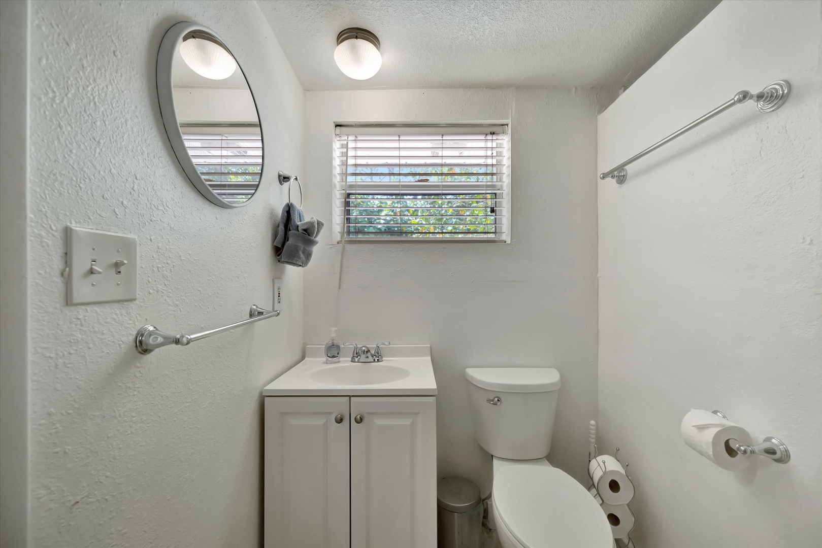 Bright, clean bathroom with everything you need to feel right at home. Natural light pours in, fresh towels await, and the vanity offers ample space for your toiletries.