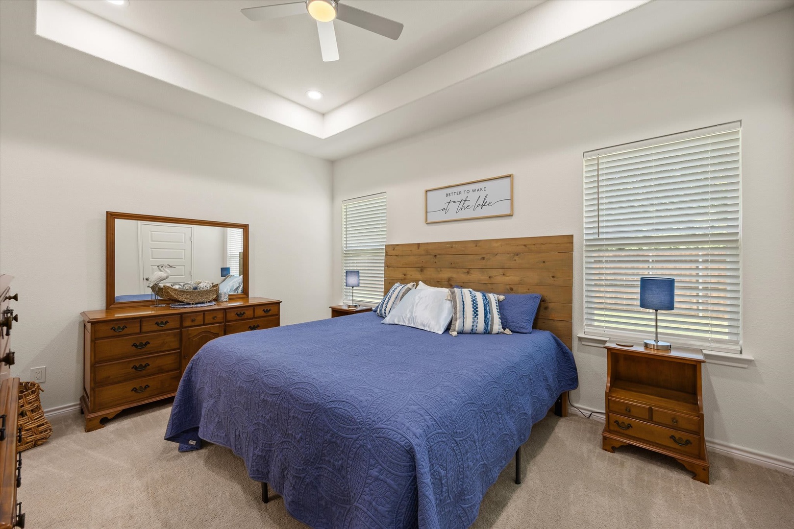 Sink into the plush bed with crisp linens and let the ceiling fan's gentle breeze lull you to rest. Your peaceful retreat awaits, beautifully appointed and perfectly serene.