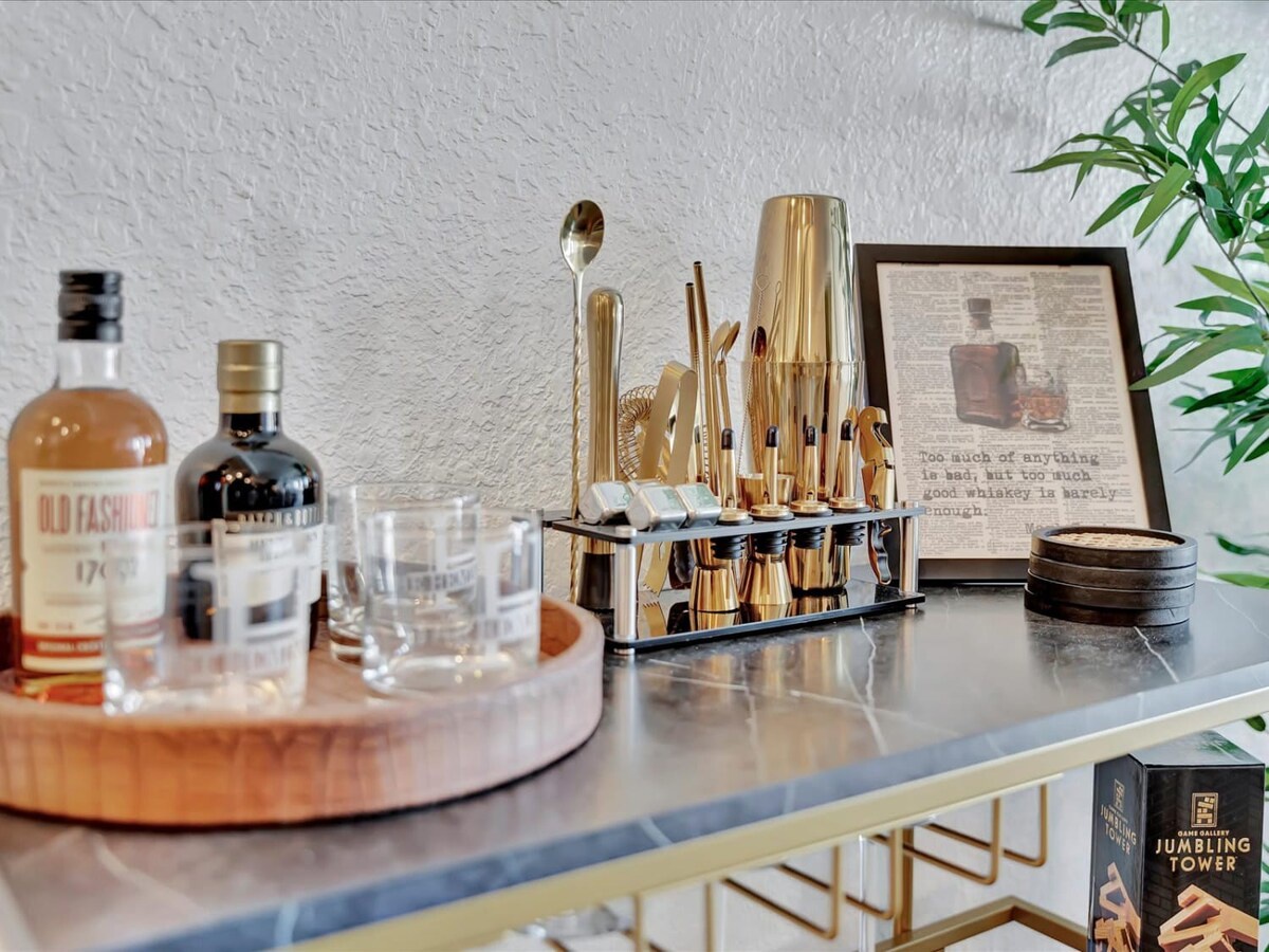 Your personal bartending station awaits, complete with golden barware and curated spirits—perfect for crafting evening cocktails in style.