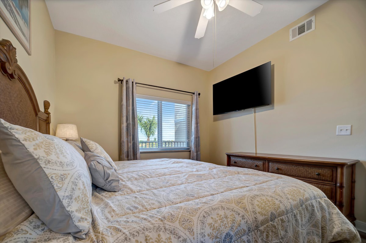 Sink into plush bedding and unwind in your serene bedroom retreat, where vaulted ceilings and soft natural light create a peaceful escape after your day's adventures.