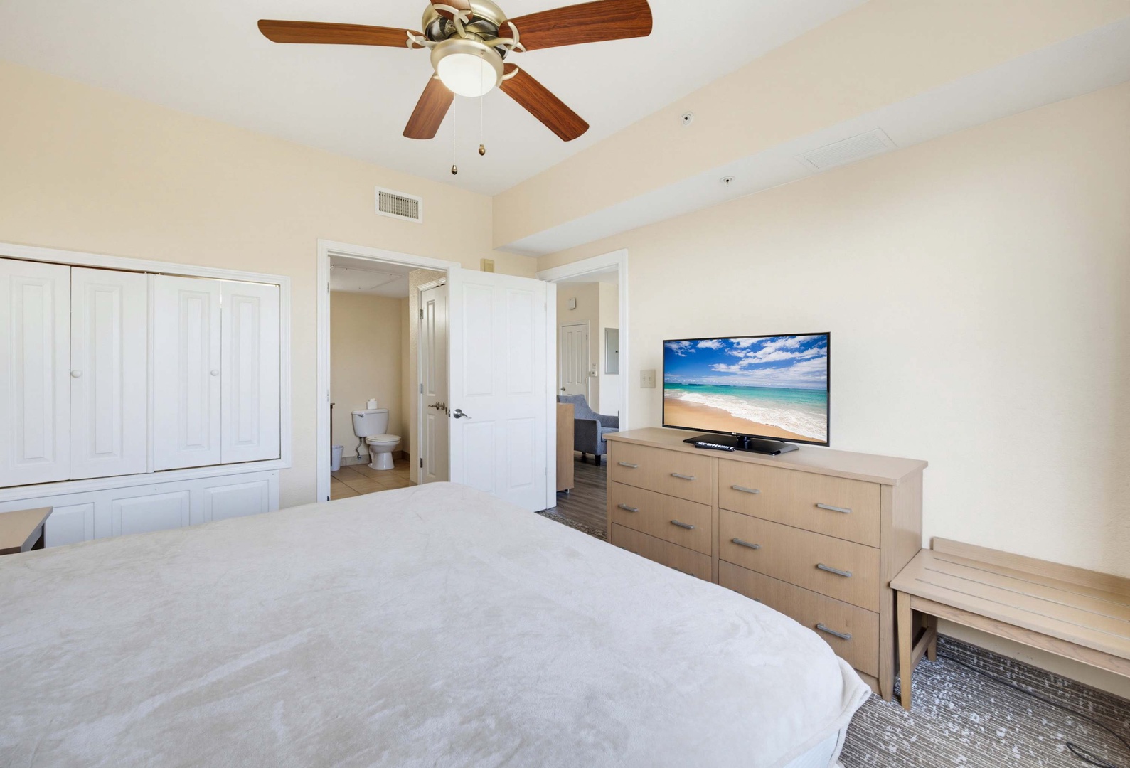 Your spacious bedroom features a plush bed, modern furniture, and ceiling fan for comfort. An en-suite bathroom awaits just steps away.