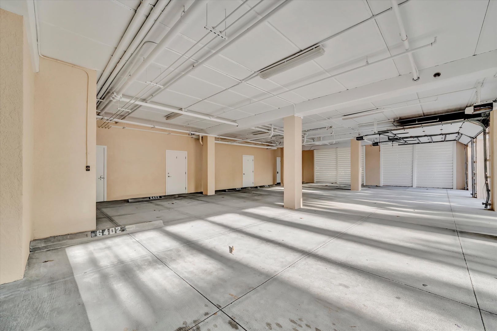 Generous covered parking area with multiple garage bays, providing secure shelter for your vehicles and plenty of additional storage space during your stay.