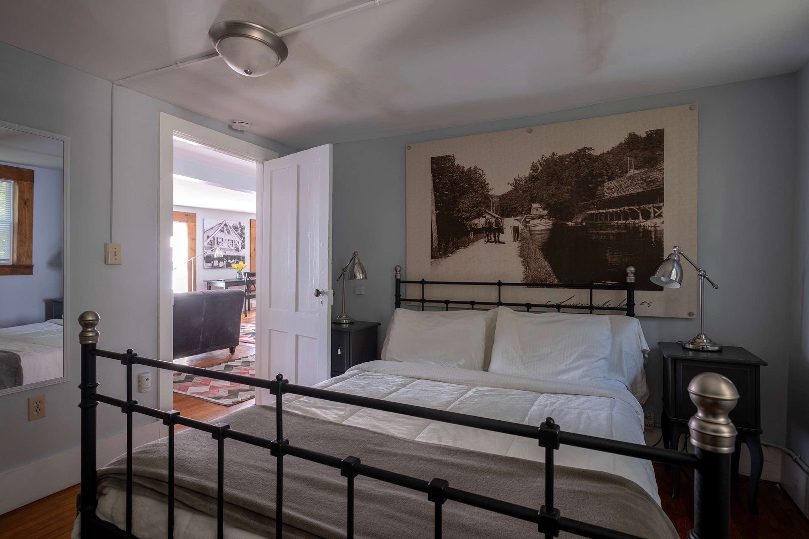Sink into crisp white linens in your tranquil bedroom, where vintage artwork and reading lamps set a cozy, nostalgic mood—your perfect retreat after a day of exploring.