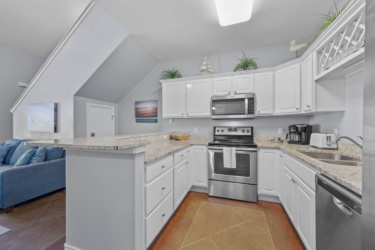 Bright open-concept space with granite counters, stainless appliances, and ample cabinets. Perfect for preparing meals while staying connected to your travel companions.