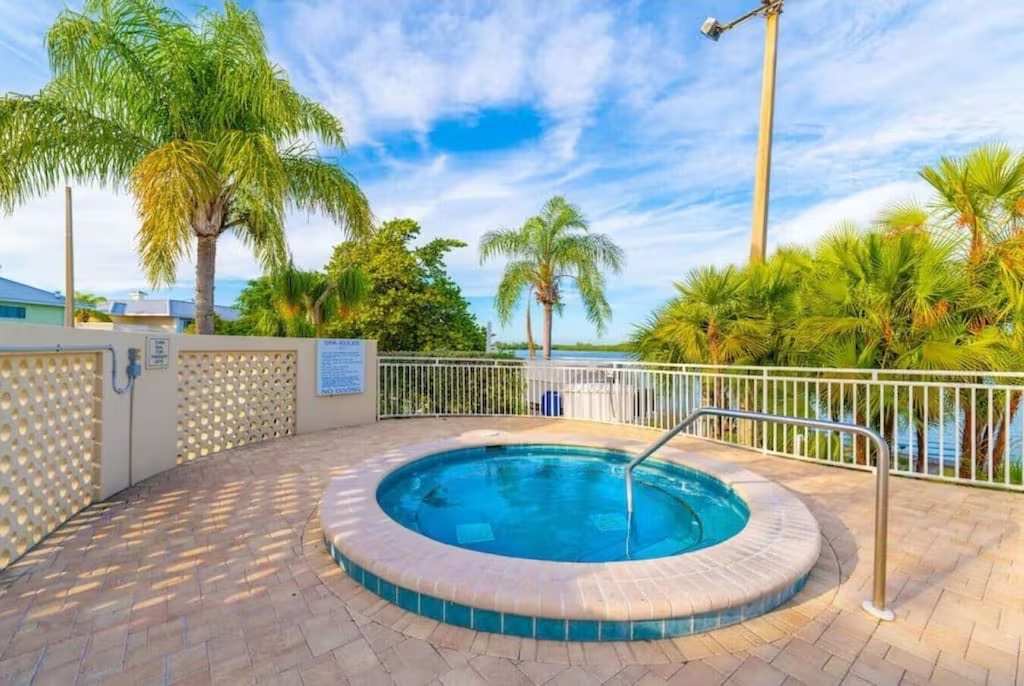 Soak in your private hot tub while tropical breezes and tranquil water views surround you—pure Florida bliss at your fingertips.