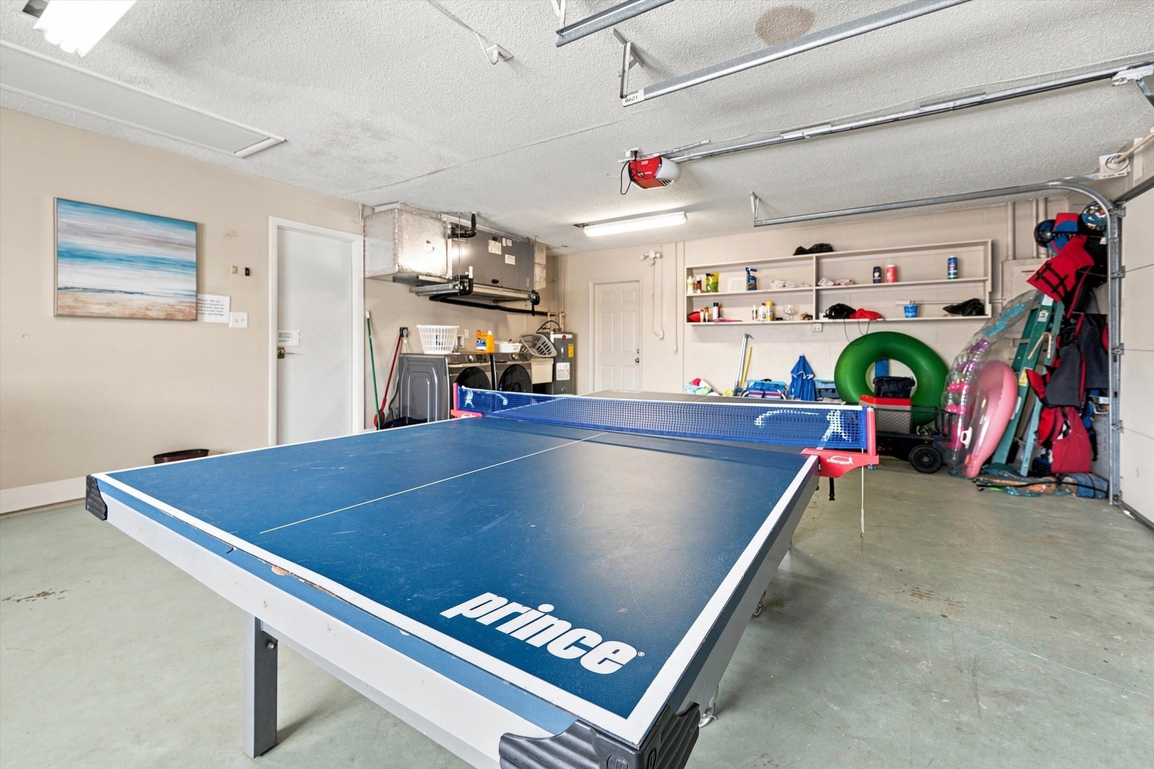 Challenge your group to a friendly match on your own table tennis setup, ready for fun in the spacious garage area.