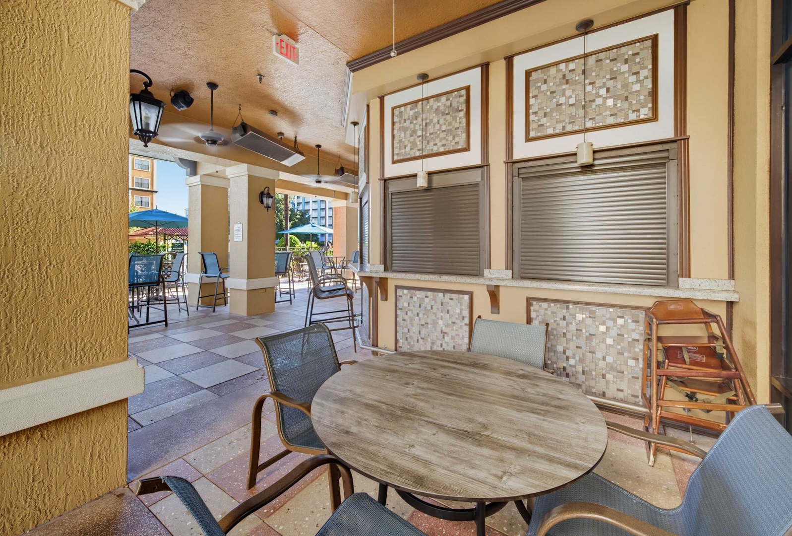 Dine al fresco at your outdoor seating area, where sunlit tables and comfortable chairs await your morning coffee or evening meal under the covered patio.