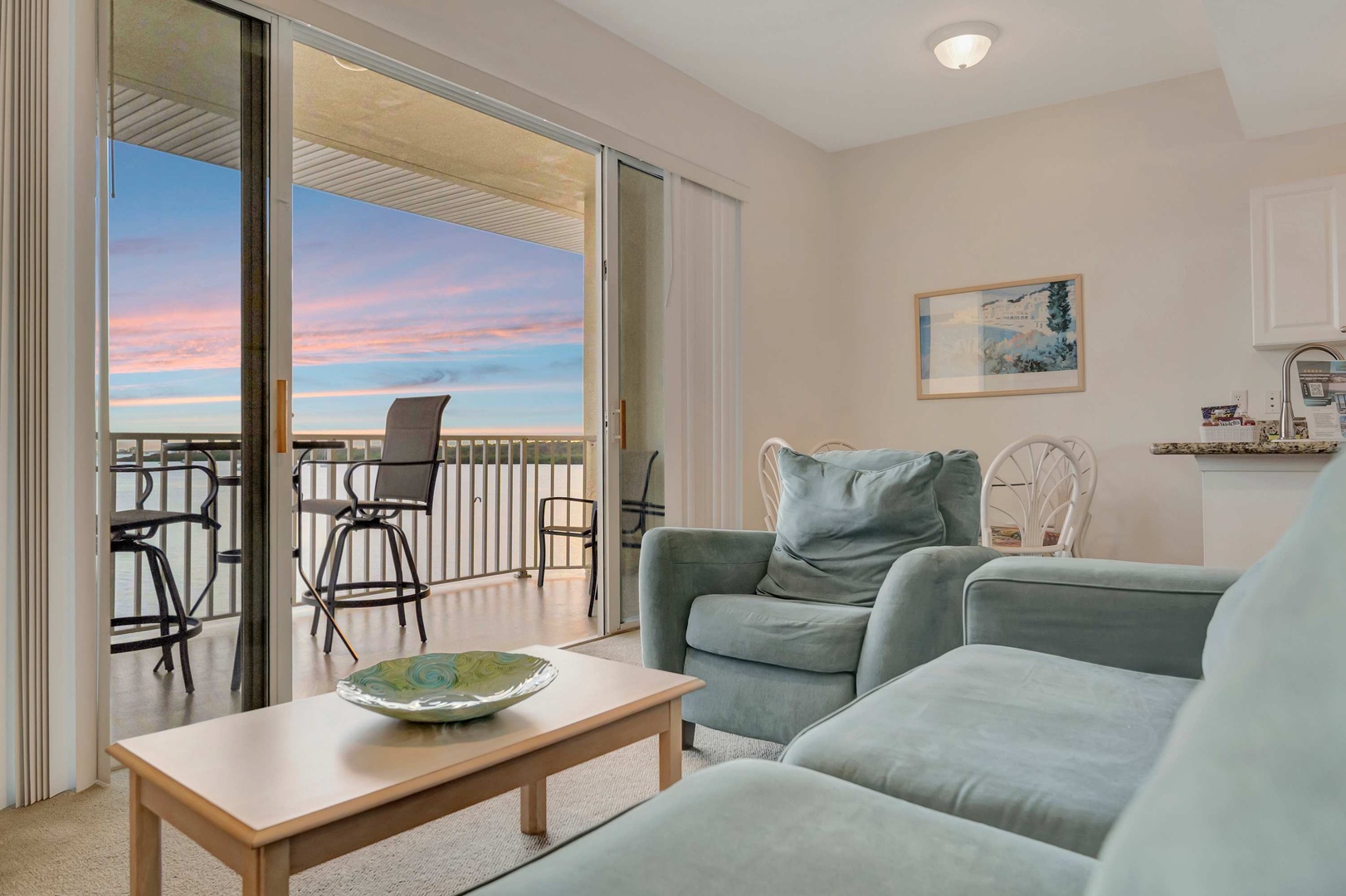 Sink into plush seating and take in the breathtaking sunset views from your private balcony. Your perfect coastal retreat awaits, where comfort meets serene beauty.