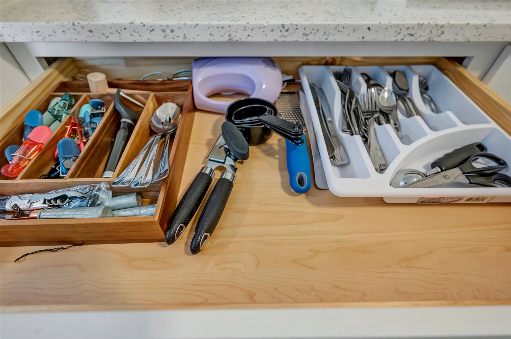 Your kitchen drawer is perfectly stocked with everything you need: measuring cups, utensils, and cooking tools all neatly organized for effortless meal prep.