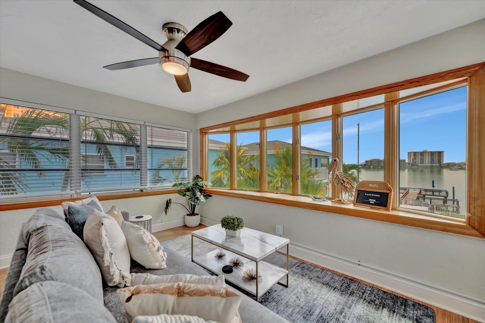 Unwind in your bright, sun-filled living space where tropical breezes drift through and palm trees frame your water views. Plush seating and coastal charm create the perfect spot to relax and recharge.