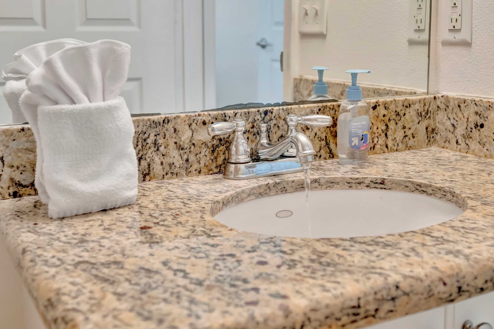 Freshly folded towels and thoughtful amenities await you at your spotless granite vanity. Step into this sparkling bathroom and feel instantly refreshed.