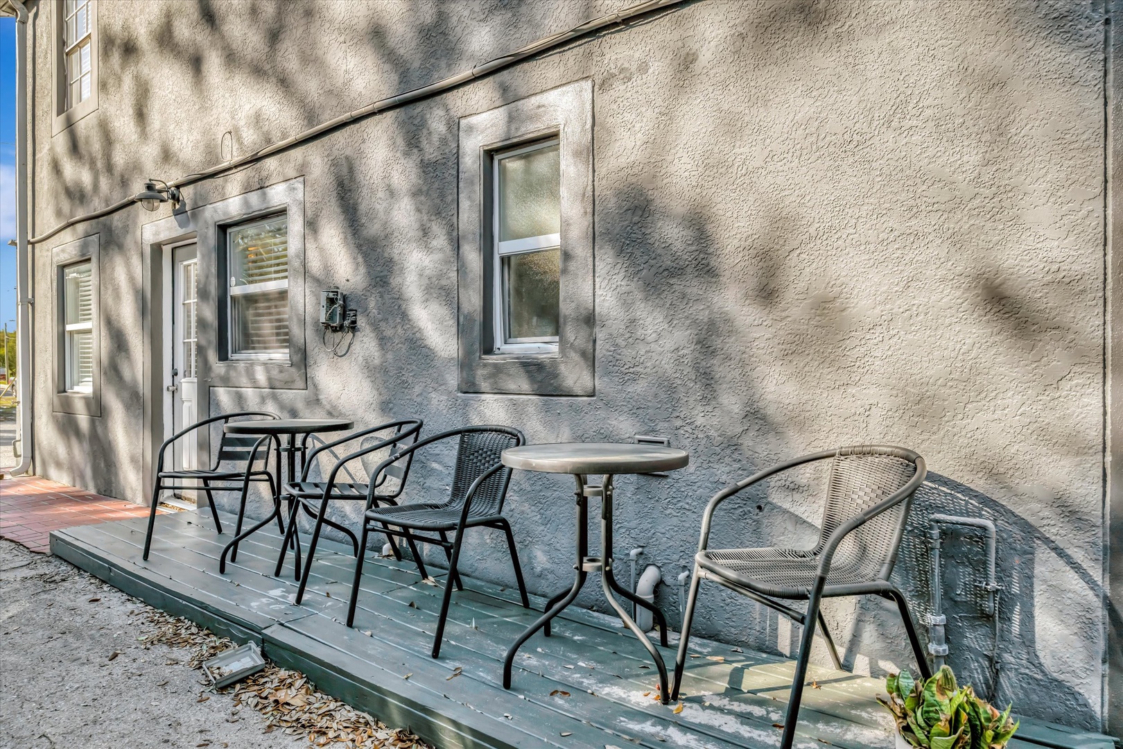 A charming private patio with comfortable seating where you can sip your morning coffee under dappled shade or unwind with an evening drink after exploring the area.