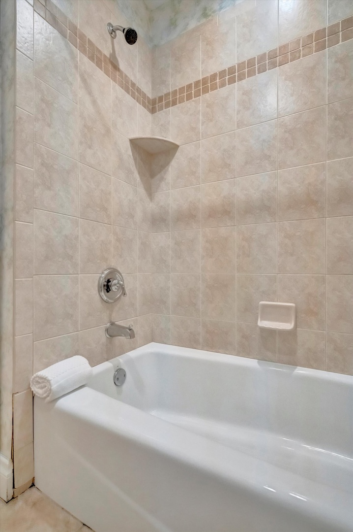 Your private tub-shower combo features elegant tiling and a sleek white finish—perfect for refreshing morning starts or soothing evening soaks.