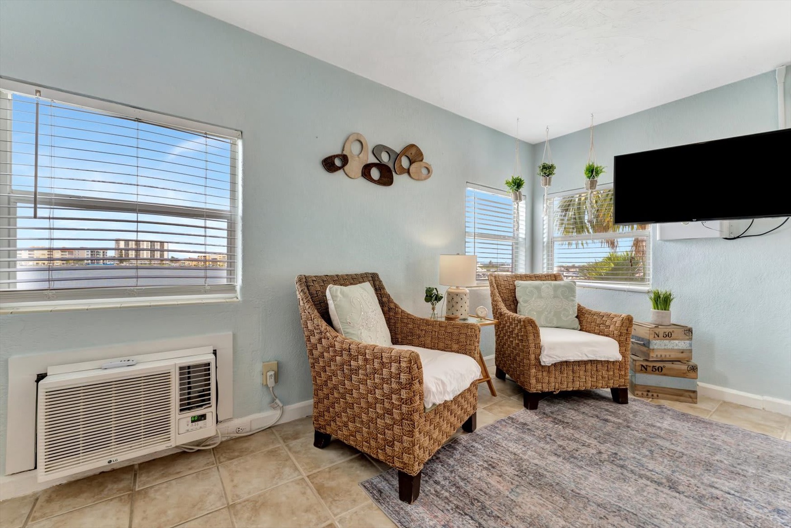 Sink into cozy wicker seating and let the ocean breeze flow through bright windows, framing palm trees and coastal charm just outside your door.