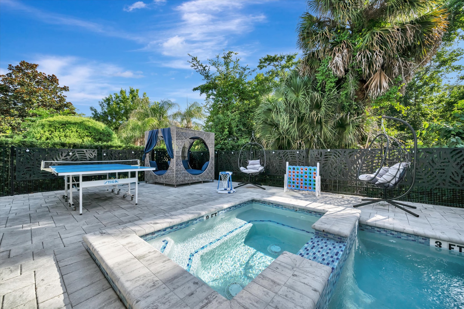 Your private outdoor oasis features a sparkling pool with built-in lounge areas, ping pong for friendly games, and cozy hanging chairs under swaying palms—perfect for sunny afternoons and relaxed evenings.