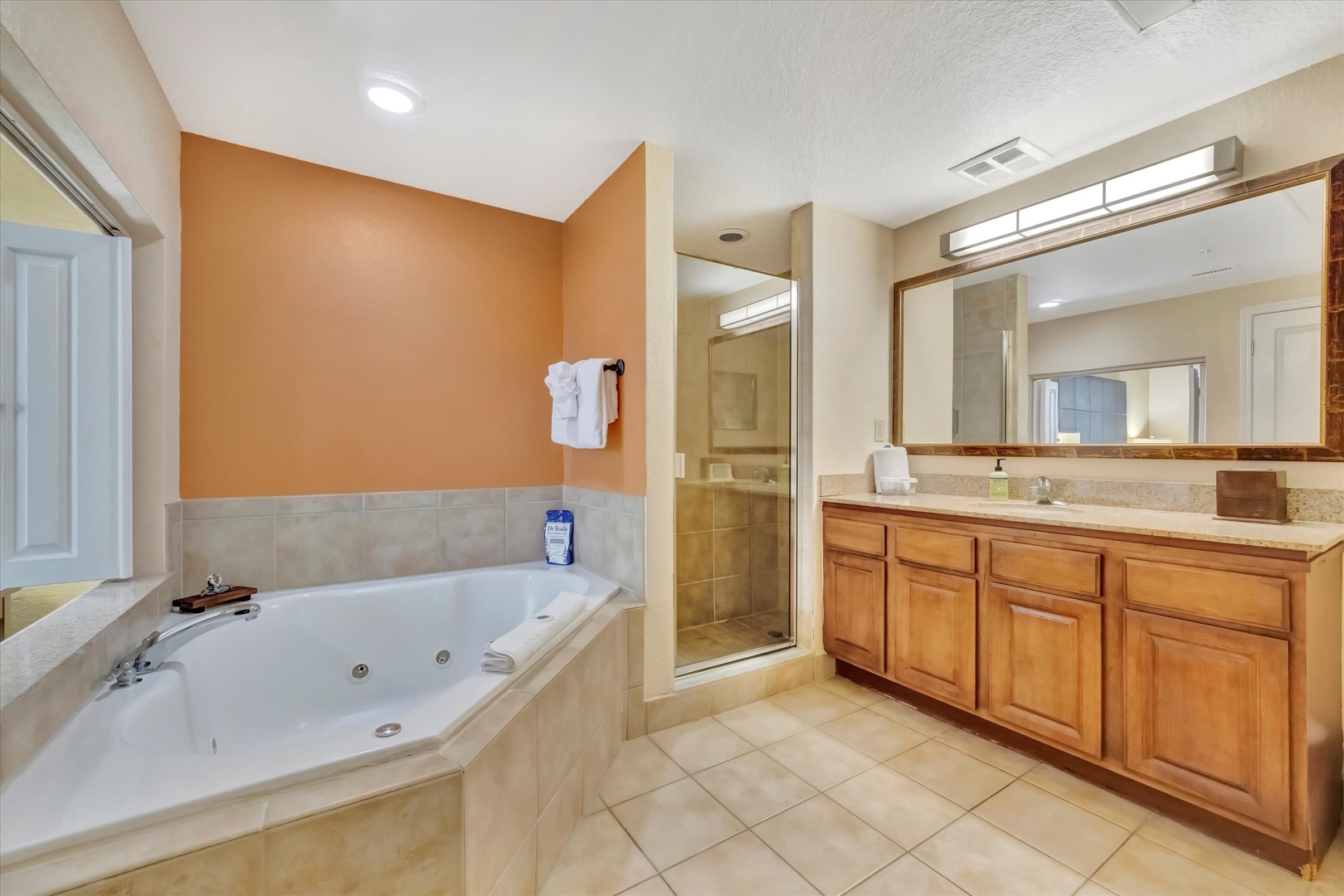 Unwind in your private spa-like bathroom, complete with a spacious jetted tub and a roomy walk-in shower, all set beneath warm tones and thoughtful finishes designed for your relaxation.