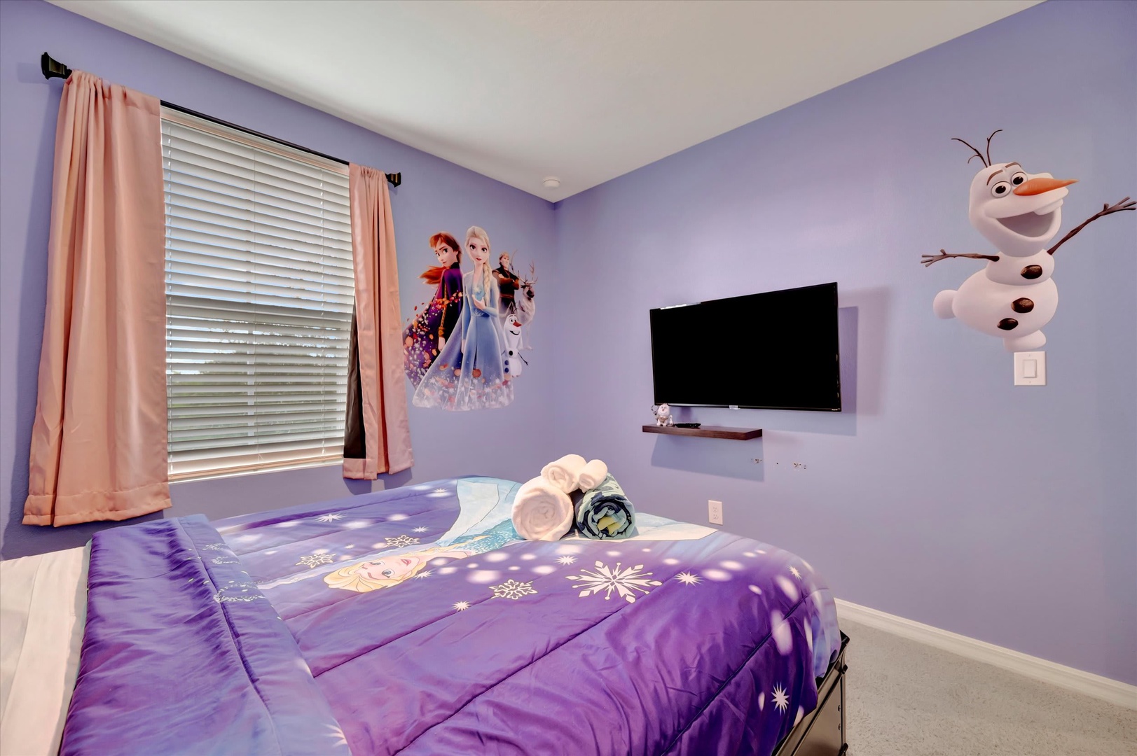 Your little ones will feel like royalty in this enchanting themed bedroom with a cozy bed, fun wall decals, and their own TV for movie nights.